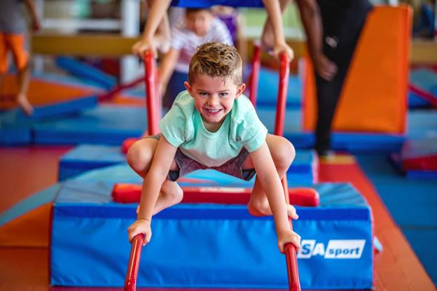 Boy climbing on balancing bars