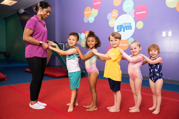 5 children at a little gym camp with a coach