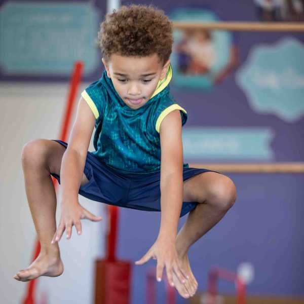 A boy jumping at the little gym