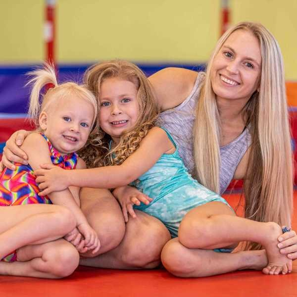 A parent and two kids at the the Little Gym
