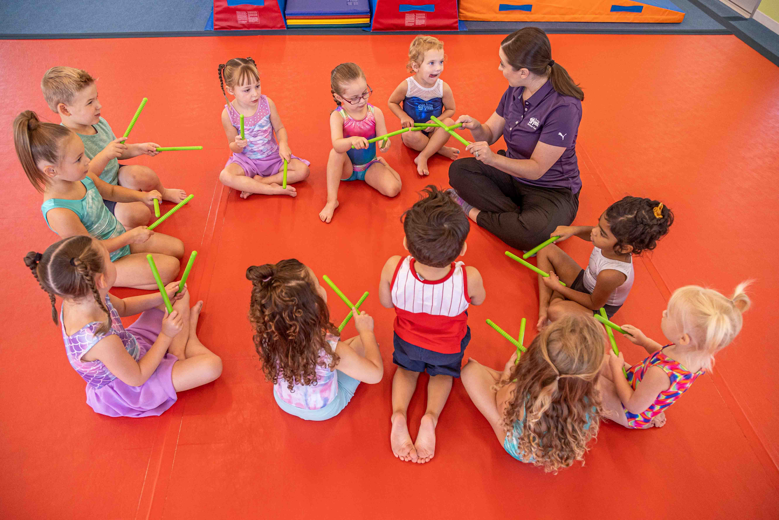 young girl doing an assisted handstand